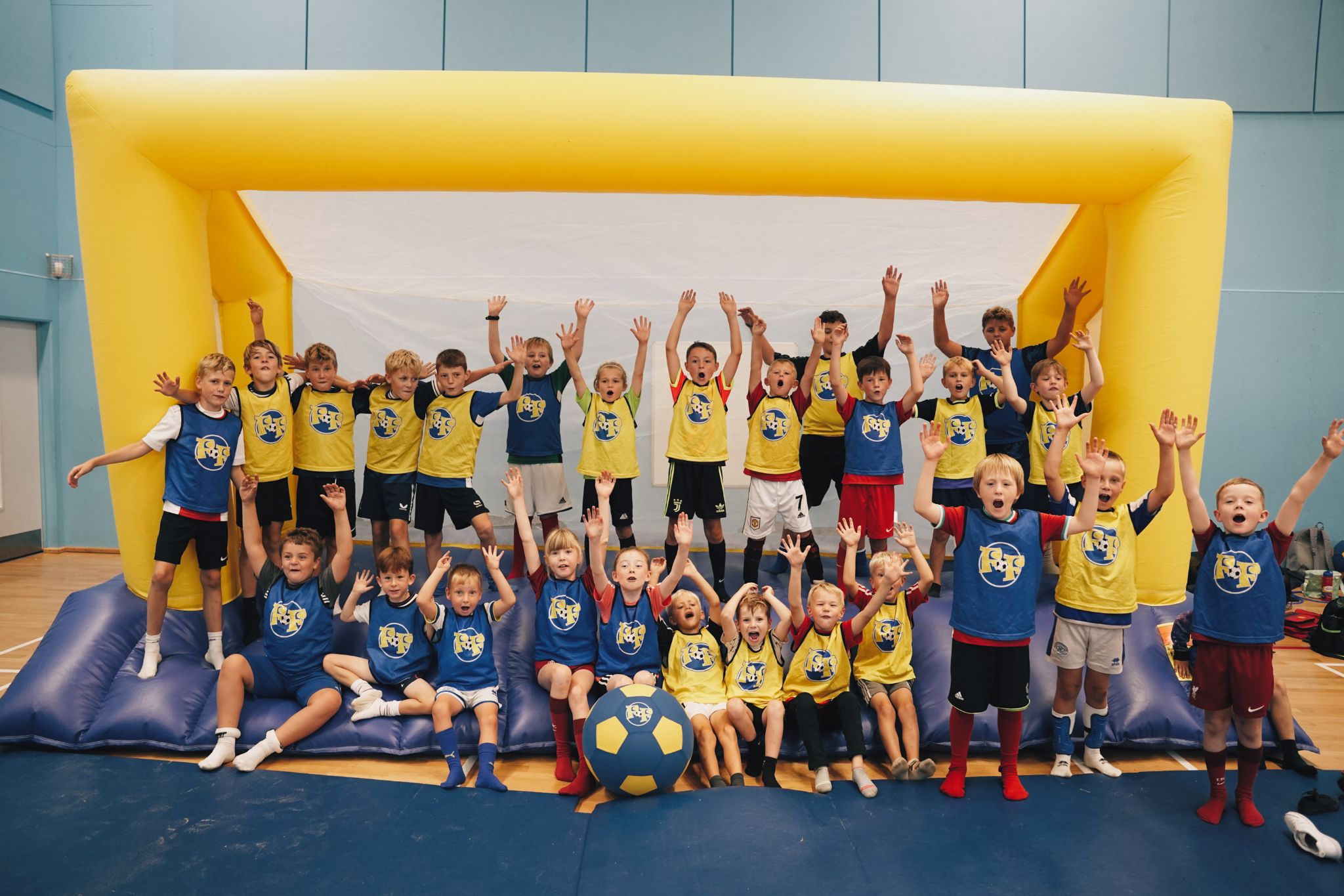 Children cheering in front of a giant inflatable goal